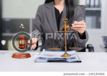 Judge in a courtroom using laptop and tablet with AML anti money laundering icon on virtual screen. 140185660