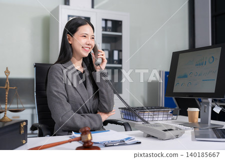 Lawyer office. gavel of Justice with scales and lawyer working on a laptop. Legal law, advice and justice concept. Lawyer office. gavel of Justice with scales and lawyer working on a laptop. Legal law, advice and justice concept. 140185667