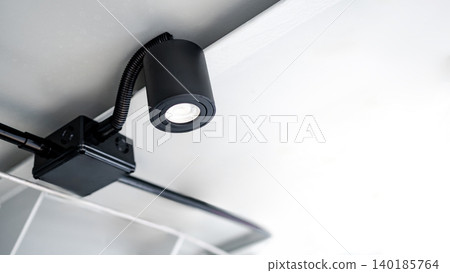 Modern black cylindrical downlight or cylinder LED spotlight hanging on the ceiling Modern black cylindrical downlight or cylinder LED spotlight hanging on the ceiling 140185764