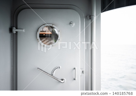 Heavy metal door with round porthole window and lever handle Heavy metal door with round porthole window and lever handle 140185768