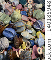 Ceramic sculptures of colorful sea urchins displayed in an artistic heap, showcasing texture 140185948