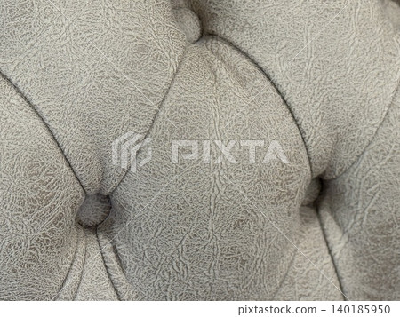 Close-up of textured gray leather upholstery with button detail, suitable for a background Close-up of textured gray leather upholstery with button detail, suitable for a background 140185950