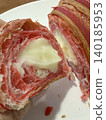 Strawberry-flavored croissant with a creamy filling, partially sliced, showing texture and layers 140185953