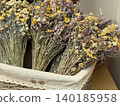 Dried flowers arranged in a rustic basket showcasing natural texture and earthy tones background 140185958