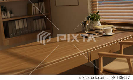 Books and coffee tea cup on wooden table beside bookshelf with sunlight shining through window blind Books and coffee tea cup on wooden table beside bookshelf with sunlight shining through window blind 140186037