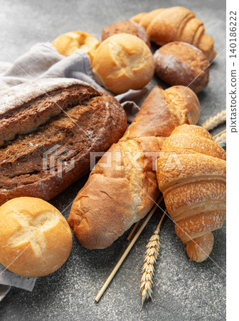 Assortment of fresh baked bread, pastry, and wheat Assortment of fresh baked bread, pastry, and wheat 140186222
