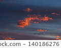 Vibrant fiery orange-red clouds at sunset.  140186276