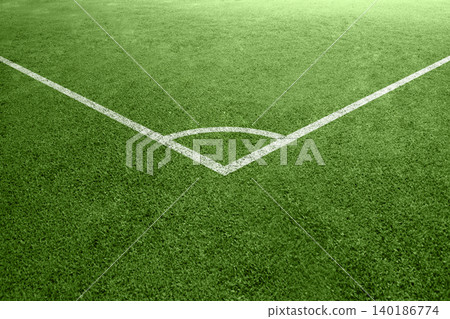 Close-up view of a corner kick area on a green soccer pitch with white painted lines on synthetic grass turf Close-up view of a corner kick area on a green soccer pitch with white painted lines on synthetic grass turf 140186774