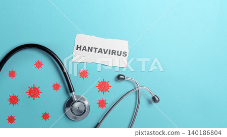 Medical concept image featuring a stethoscope, red virus icons, and a piece of paper with the word Hantavirus on a blue background Medical concept image featuring a stethoscope, red virus icons, and a piece of paper with the word Hantavirus on a blue background 140186804