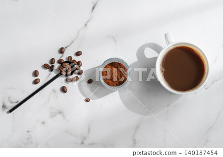 Freshly brewed espresso coffee in a cup on a white marble background Freshly brewed espresso coffee in a cup on a white marble background 140187454