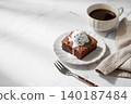 A piece of chocolate brownie with ice cream on a plate and a cup of espresso coffee 140187484