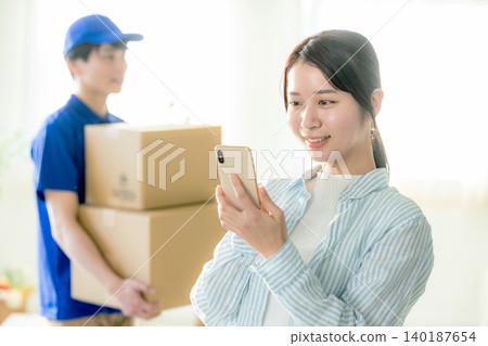 Courier woman delivering luggage Courier woman delivering luggage 140187654