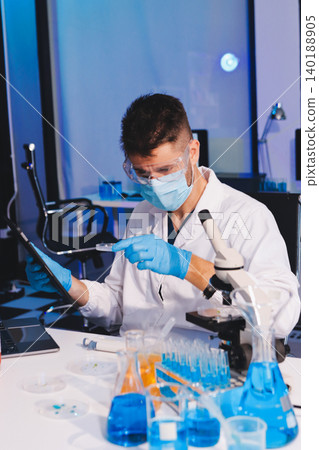 Lab technician experimenting in lab Lab technician experimenting in lab 140188905