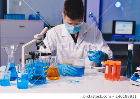 Lab technician experimenting in lab 140188911
