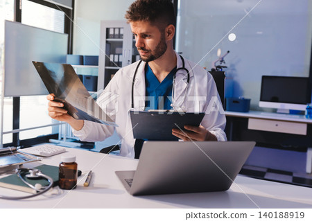 Man, doctor and laptop typing in healthcare research, communication or social media at office desk. Male medical expert working on computer in online search, browsing or chatting on tablet at clinic Man, doctor and laptop typing in healthcare research, communication or social media at office desk. Male medical expert working on computer in online search, browsing or chatting on tablet at clinic 140188919