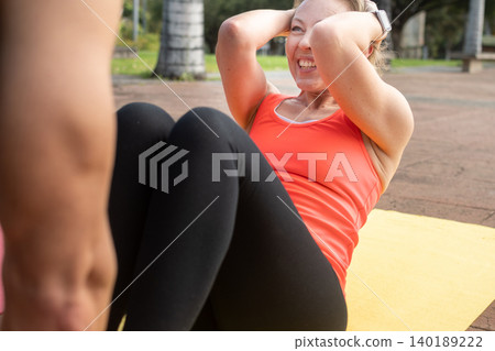Mature Woman Doing Abs Workout on Yoga Mat Outdoors 140189222