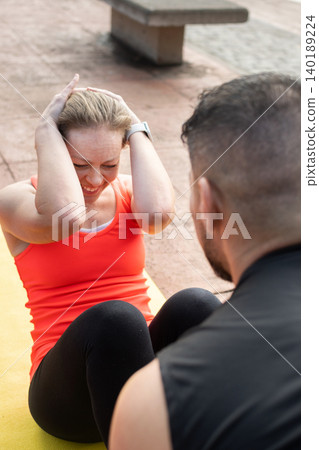 Mature Woman Doing Abs Workout on Yoga Mat Outdoors Mature Woman Doing Abs Workout on Yoga Mat Outdoors 140189224