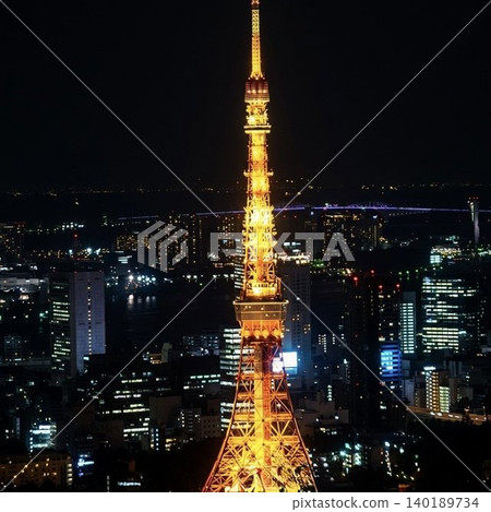 The Tokyo Tower, beautifully illuminated and shining against the Tokyo night sky, and the night view of the metropolis's skyscrapers. The Tokyo Tower, beautifully illuminated and shining against the Tokyo night sky, and the night view of the metropolis's skyscrapers. 140189734
