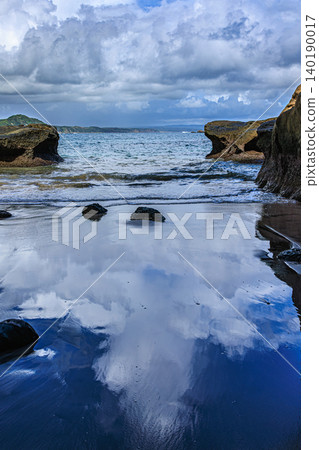 The reflection of cumulonimbus clouds on the seashore at Senza no Iwaya The reflection of cumulonimbus clouds on the seashore at Senza no Iwaya 140190017
