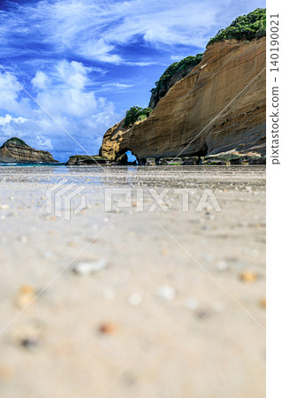The stunning beach at Senza-no-Iwaya boasts a beautiful combination of blue skies and uniquely shaped rock formations. The stunning beach at Senza-no-Iwaya boasts a beautiful combination of blue skies and uniquely shaped rock formations. 140190021