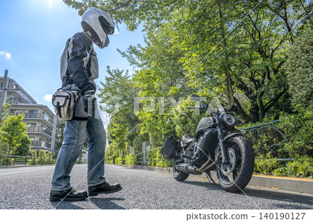 Preparations for a touring trip with a large American motorcycle and a male rider Preparations for a touring trip with a large American motorcycle and a male rider 140190127