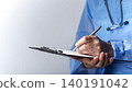 Female caucasian doctor filing papers in clipboard. Healthcare background with copy-space 140191042