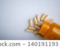 Health care background of pills and bottle on white surface flat lay 140191193