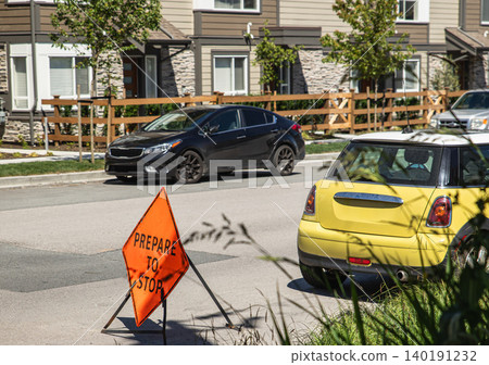 Roadworks with Orange metal Sign Prepare to Stop on the city street. A road construction sign warns oncoming traffic. Nobody, street photo. Construction, road repair works and safety signage concept 140191232