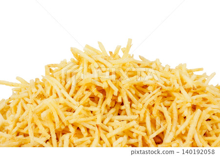 Stacked shoestring potatoes isolated on a white background. A traditional side dish in Brazilian cuisine Stacked shoestring potatoes isolated on a white background. A traditional side dish in Brazilian cuisine 140192058