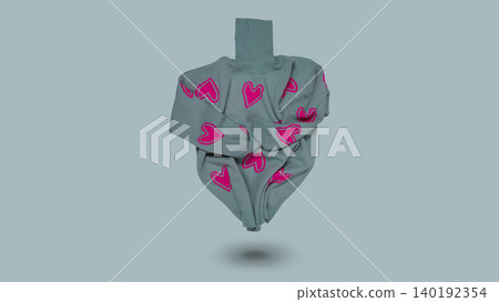 Cozy grey knitted turtleneck sweater with pink hearts print levitating on light blue background, copy space. Cozy grey knitted turtleneck sweater with pink hearts print levitating on light blue background, copy space. 140192354