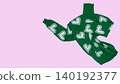 Green knitted turtleneck sweater with white hearts pattern floating in air on pink background, copy space. 140192377