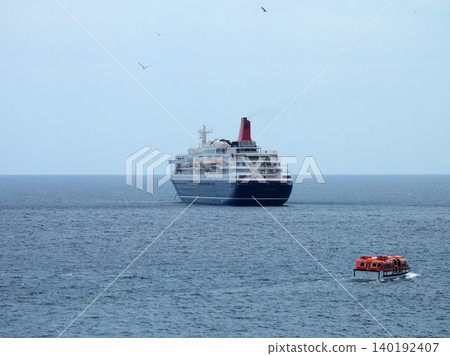 A cruise ship anchored off the coast of Yaene Fishing Port on Hachijo Island. A cruise ship anchored off the coast of Yaene Fishing Port on Hachijo Island. 140192407