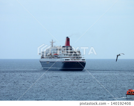 A cruise ship anchored off the coast of Yaene Fishing Port on Hachijo Island. A cruise ship anchored off the coast of Yaene Fishing Port on Hachijo Island. 140192408