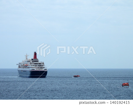 A cruise ship anchored off the coast of Yaene Fishing Port on Hachijo Island. A cruise ship anchored off the coast of Yaene Fishing Port on Hachijo Island. 140192415