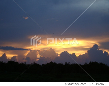 The silhouette of cumulonimbus clouds floating in the sunset sky 140192870