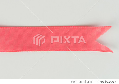 Bright pink ribbon sits on a plain background Bright pink ribbon sits on a plain background 140193092