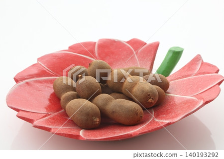 Tamarind on a wooden plate Tamarind on a wooden plate 140193292
