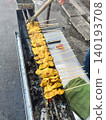 Chicken satay grilled skewer street food charcoal grill barbecue food vendor marinade turmeric sizzling meat roadside grill 140193708