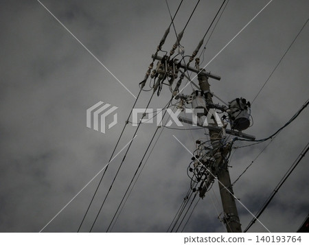夜空中,電線桿和輸電線路延伸至天際,構成了一幅靜謐的城市景觀。 夜空中,電線桿和輸電線路延伸至天際,構成了一幅靜謐的城市景觀。 140193764