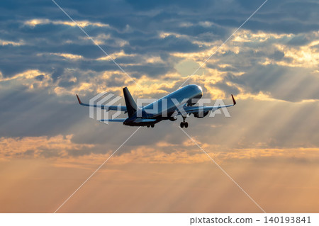 Modern passenger airplane takes off into the sunrise sky Modern passenger airplane takes off into the sunrise sky 140193841