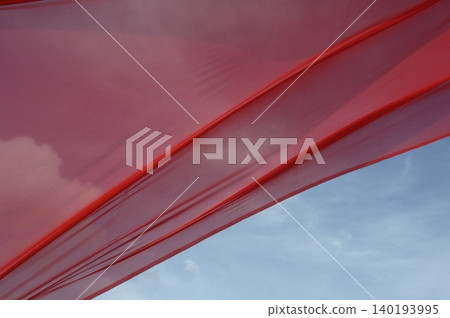 Red Color Cloth Flying In Wind 140193995
