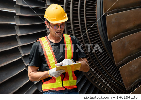 Professional engineer male working service power plant turbine fan blade electrical generator Professional engineer male working service power plant turbine fan blade electrical generator 140194133