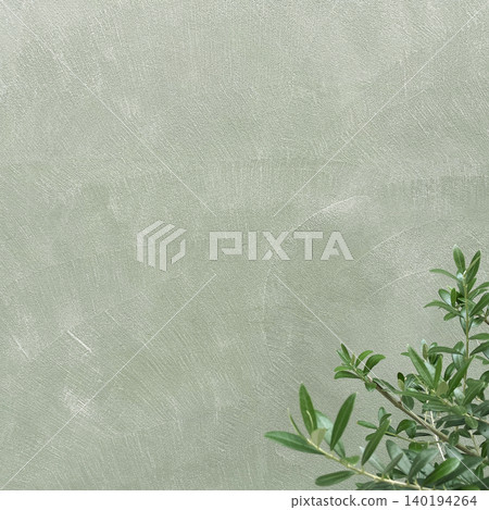 A square background image featuring green olive branches and leaves in front of a pale olive-colored wall. A square background image featuring green olive branches and leaves in front of a pale olive-colored wall. 140194264
