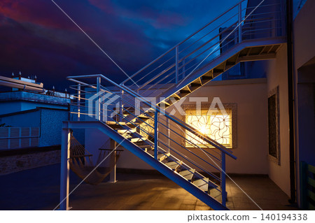 House window light glow in a thunder storm House window light glow in a thunder storm 140194338