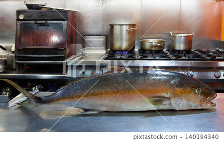 Amberjack fish in pro kitchen on stainless Amberjack fish in pro kitchen on stainless 140194340