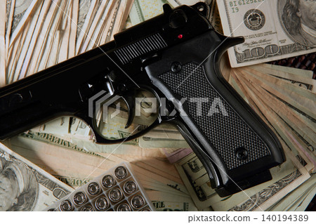 Dollar notes and gun, black pistol Dollar notes and gun, black pistol 140194389