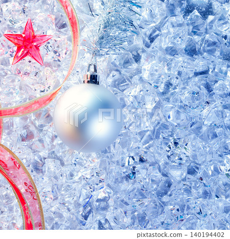 christmas silver bauble and red ribbon on ice christmas silver bauble and red ribbon on ice 140194402
