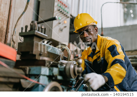 Professional African black Engineer male worker work with metal lathe machine in metal part factory Professional African black Engineer male worker work with metal lathe machine in metal part factory 140194515