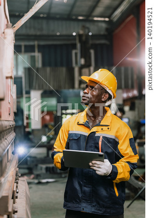 Professional African black engineer male technician expert worker control operate machine in plant Professional African black engineer male technician expert worker control operate machine in plant 140194521