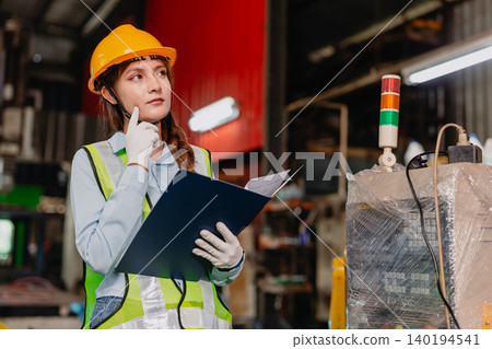Professional Engineer female worker supervisor Thinking in heavy industry metal factory with safety 140194541